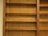 a large wooden bookcase with many shelves in it