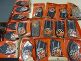 many bags of orange and black items on a table