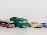 a lot of toy cars that are lined up on the floor