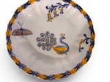 an image of a white bowl with blue and yellow designs on it