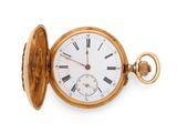 a gold pocket watch with roman numerals on it
