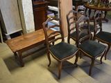 several chairs and a table in a room with a lot of furniture