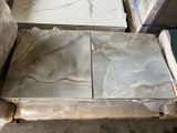 two pieces of marble on a pallet in a warehouse