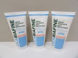 three tubes of toothpaste sitting on top of a white counter