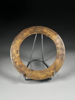 an image of a metal sculpture of a circular object on a stand