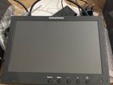 a small monitor sitting on top of a cardboard box