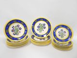 a set of six blue and yellow plates with flowers on them