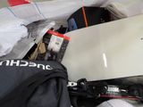 a white laptop computer sitting on top of a pile of luggage