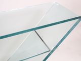a glass table with a glass shelf on top of it