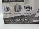 packaging of a black and white steam iron sitting on top of a table