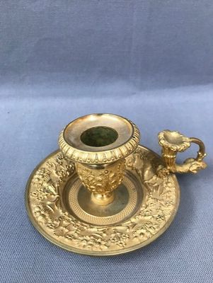 a gold cup and saucer on a blue cloth