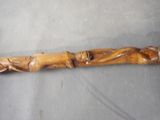 a wooden stick with carvings on it sitting on a table