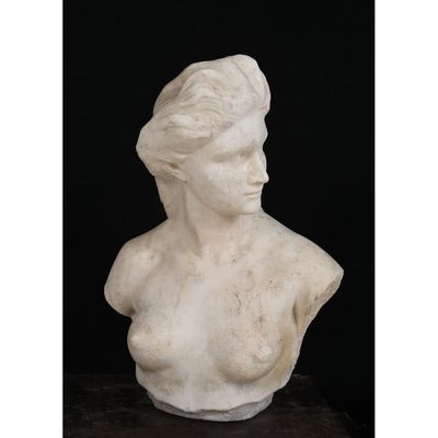 a white marble bust of a woman on a black background