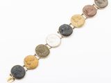 a gold bracelet with five different colored stones on a white background