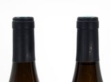two bottles of wine sitting next to each other on a table