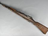 an old rifle with a wooden barrel and a wooden handle