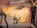 a close up of an old motorcycle with a saddle on it