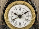 a close up of a clock with roman numerals on it