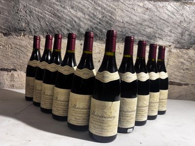 several bottles of wine are lined up in a row on a table