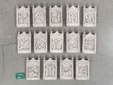 six white ceramic sculptures of people and animals on a gray surface
