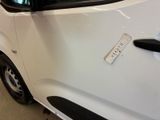 a small white car with a sticker on the side of it