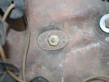 a close up of a piece of metal with nuts on it