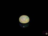 an image of a white fire opal in the dark