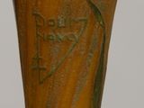 a close up of a vase with a bird on it