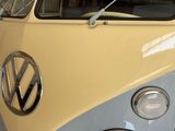 a yellow and blue vw bus parked in a garage