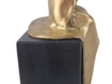statue of a person sitting on a block with a dog on it