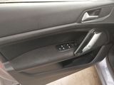 the interior of a car with the door open and the driver ' s seat down