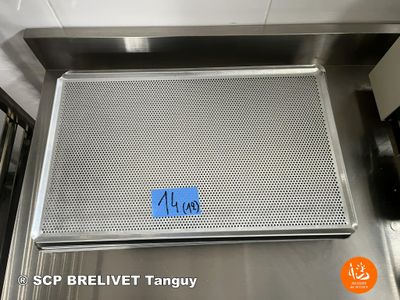 a picture of a stainless steel grill with a blue tag on it