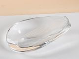 a glass bowl on a table with a spoon on it