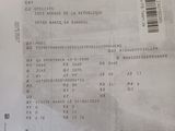the receipt of a man who is driving a car has a barcode on it
