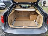a trunk of a car with a surfboard in it