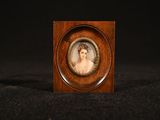 an antique miniature portrait of a woman in a wooden frame