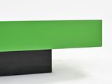 a close up of a green and black bench on a white surface