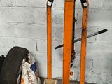a fork lift with a tire on it in a garage