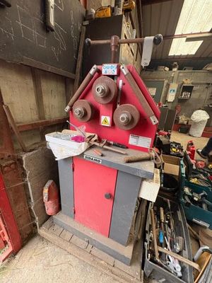 a red machine that is sitting in a garage