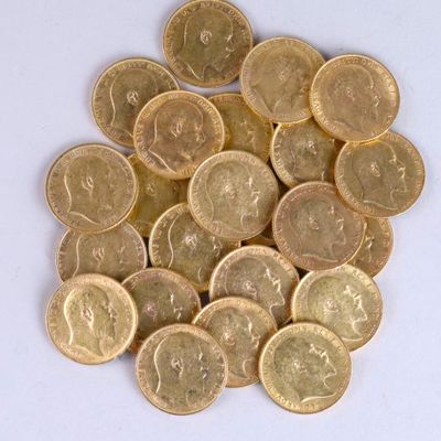 a pile of gold coins sitting on a white surface