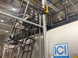 a large tank with a ladder in the middle of it