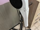 a hair dryer sitting on a stand in a room