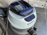 a vacuum that is sitting on the floor next to a bag