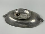 a silver plate with a gold ring on it