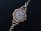 an image of a close up of a wrist watch on a chain