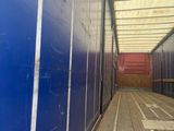 a long hallway with blue walls and wooden flooring