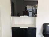 a black and white cabinet in the corner of a room