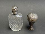 a small glass bottle and a small glass bottle on a table