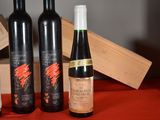 several bottles of wine are sitting on a table with a wooden box