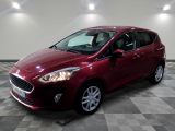 the red ford fiesta is parked in a room with a checkered floor